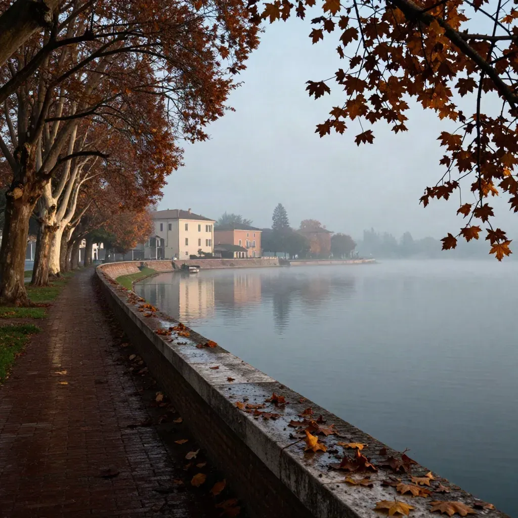 Passeggiata di Mantova sul lago con platani autunnali e palazzi nella foschia
